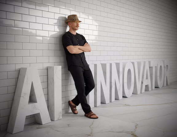 Jeremy Och, founder of OchAI, leaning against large marble letters that read AI Innovator